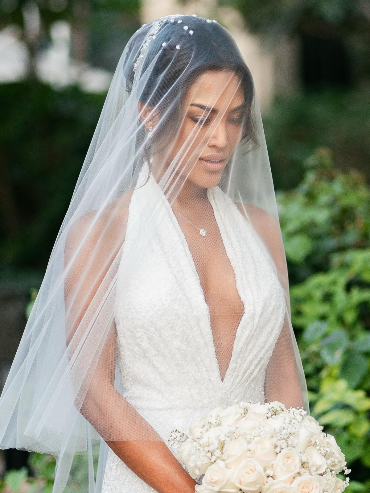 Bride beneath a couture veil in a beaded gown — Haniye Dubai